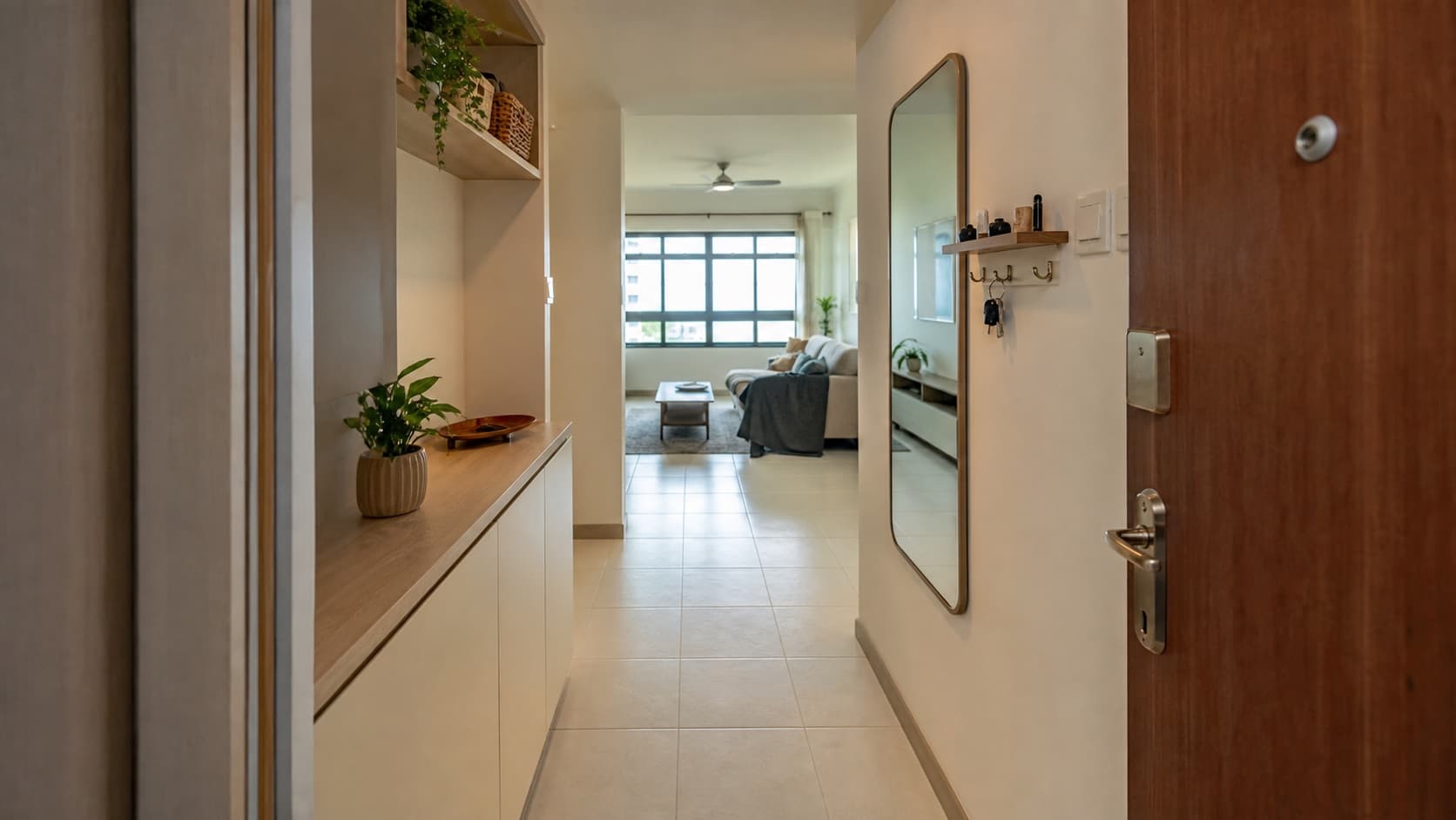 Compact HDB entrance foyer with slim storage and an open path to the living room