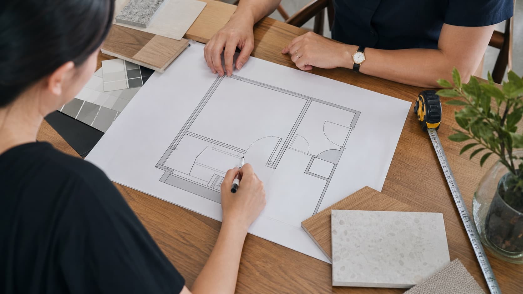 Homeowner reviewing an HDB foyer plan with door swings and clear circulation marked